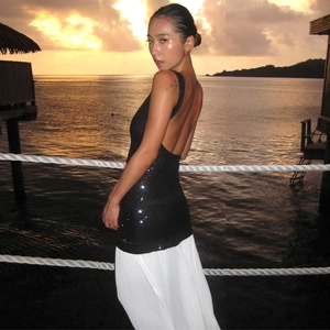 Detail of sexy backless sequin top and white pleated long skirt for summer beachwear