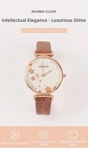 Detail of classic vintage women's quartz watch with brown leather strap and floral dial