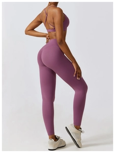Close-up of mauve high-waist yoga pants and cross-back sports bra with matte finish