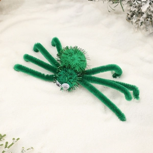Close-up of a handmade green fuzzy spider hair clip for Halloween party decoration