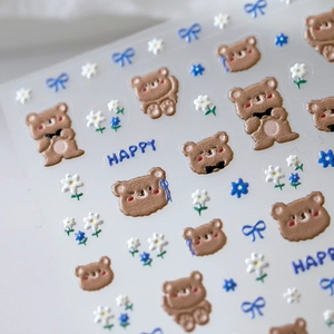 3D relief nail stickers featuring cute brown bears and blue floral bow designs