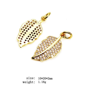 Detailed close-up of gold-plated leaf pendants with micro-paved zircons for DIY jewelry