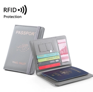 Grey PU leather RFID passport holder featuring card slots and elastic closure strap