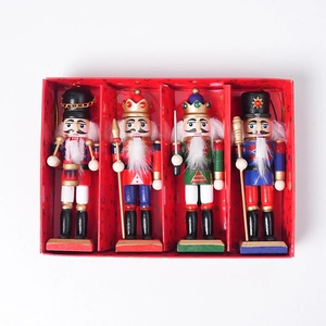 Detail of four 13cm glitter wooden nutcracker soldier ornaments in a festive red gift box