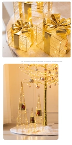 Detail view of lit Christmas iron gift box and glowing cone tree with festive LED lights