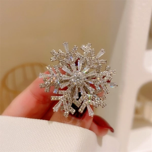Macro close-up of rotating snowflake brooch with zircon crystals in silver finish