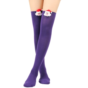 Detail of purple knitted over-the-knee socks with a 3D plush Santa Claus at the top