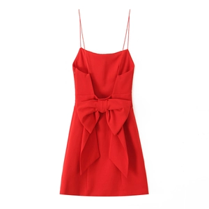 Elegant red spaghetti strap mini dress featuring a large bow detail on the back