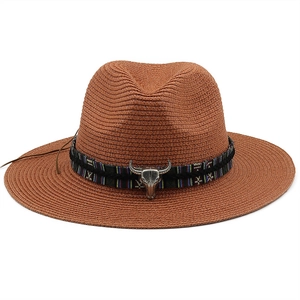 Detailed macro view of woven straw hat texture with ethnic band and silver bull head ornament