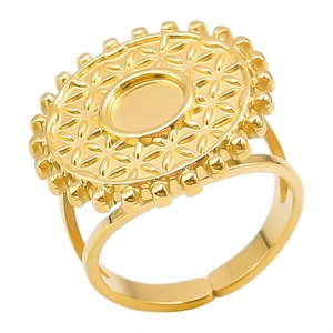 Macro detail of golden vintage ring featuring a geometric floral engraving and open band