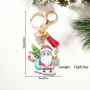 Cute Santa Claus Christmas keychain with red tassel and acrylic tag on a festive backdrop