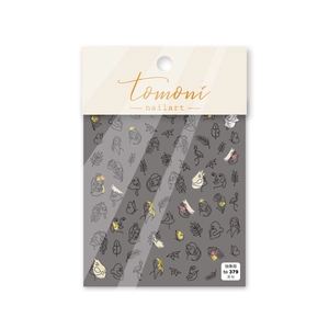 Detailed view of abstract line art nail stickers with faces and leaves in packaging