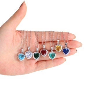 Set of colorful heart pendants with zircon stones on fine cross chains in seven bright colors