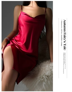 Detailed view of the V-neckline and smooth silk satin texture on the red slip dress
