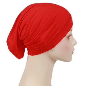 Close-up of bright red modal hijab cap with elastic pleated texture on a mannequin