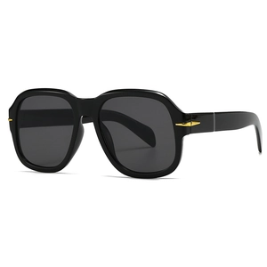 Modern flat top sunglasses in black with grey lenses and gold arrow temple detail