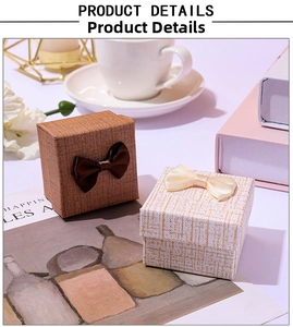 Detailed view of textured square jewelry gift boxes with elegant silk bow ties