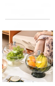 Detail of luxury glass fruit bowl with silver bear handle and elegant pedestal stand