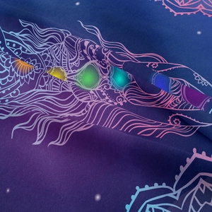 Detailed macro view of high-quality mandala tapestry with glowing chakra feather patterns