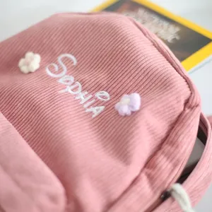 Pink corduroy backpack with personalized Sophia embroidery and 3D floral accents
