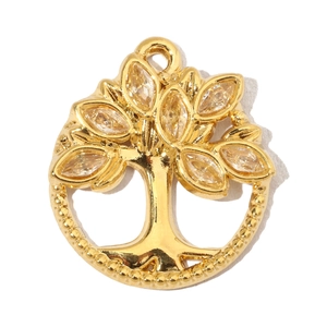 Detailed macro view of a gold tree of life pendant with marquise-cut crystal leaves