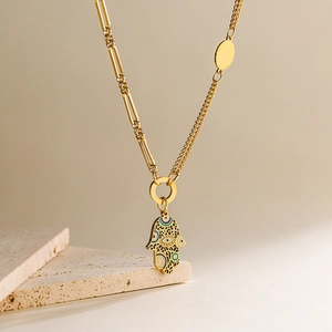 18K gold plated Hamsa Hand necklace with blue evil eye on asymmetric chain