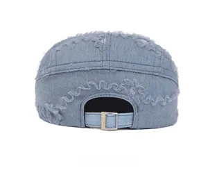Detail view of denim baseball cap back featuring lace trim and adjustable metal buckle