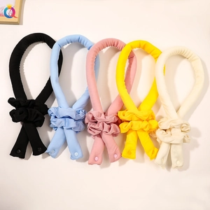 Detailed view of colorful heatless hair curler sets with snap buttons and soft fabric