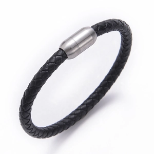 Detail of black braided leather bracelet featuring a silver stainless steel magnetic clasp