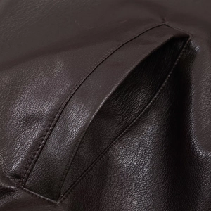 Detailed close-up of dark brown faux leather texture and reinforced pocket stitching