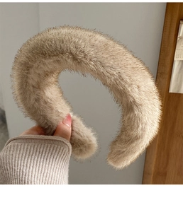 Close-up of a wide brown faux mink fur headband showing soft plush texture and fluffy fibers