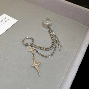 Detailed close-up of silver star zircon ear cuff with double chains on velvet tray