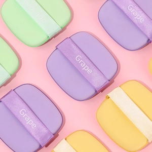 Colorful ultra-soft cushion powder puffs in purple, green and yellow with ribbon handles