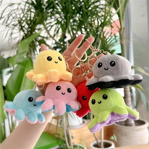 Close-up of colorful plush octopus keychains with smiling faces and golden metal clips
