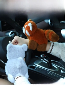 Plush red panda and raccoon snap bracelets shown as decorative car interior accessories