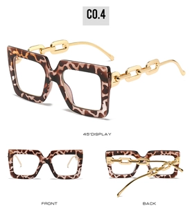 Detail of oversized leopard print glasses frame with chunky gold chain metal temples