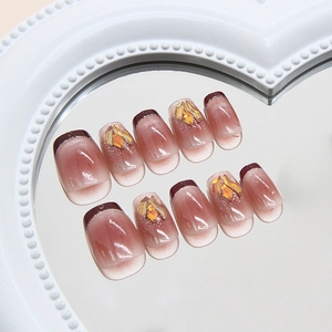 Cat eye press-on nails with silver glitter lines and rhinestones on a heart mirror