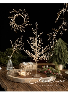 Detailed view of luxury golden acrylic crystal beads on a Christmas tree branch