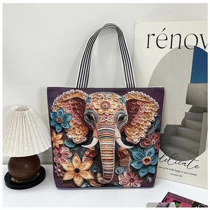 Detailed embroidery of elephant and floral patterns on purple canvas tote bag with striped strap