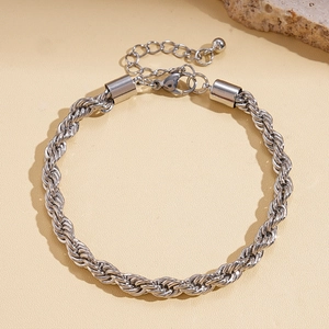 Detailed macro view of silver braided twist chain bracelet with lobster clasp and extender