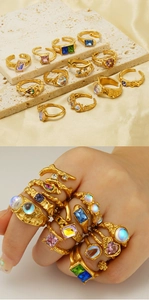 Macro detail of vintage adjustable moonstone rings with irregular gold textures and colorful gems
