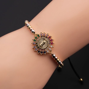Detailed view of adjustable beaded bracelet with colorful zircon and Virgin Mary charm