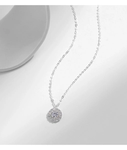 Macro detail of S925 sterling silver necklace with sparkling round halo pendant