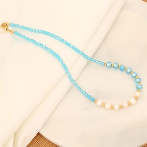 Detail of handmade eye necklace with blue crystal beads and white pearls on silk