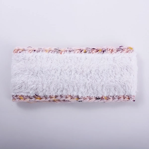 Detailed view of white faux fur headband with colorful knit edges and soft texture
