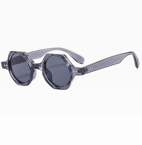 Detail view of octagon grey translucent sunglasses frames with silver stud accents