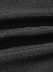 Macro shot of black corduroy fabric texture showing fine vertical ridges and twill weave
