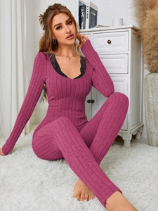 Close-up of ribbed long-sleeve pajama set with black lace V-neck detail in vibrant rose red