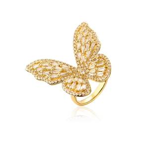 Macro view of gold butterfly ring with inlaid white cubic zirconia and mirror reflection