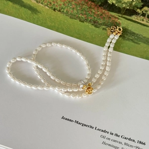 Elegant double-layered 925 silver pearl necklace featuring a gold rose floral pendant